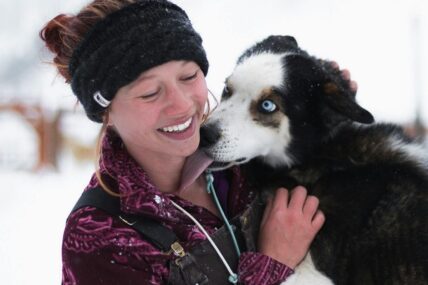 Dog licking a woman's face.