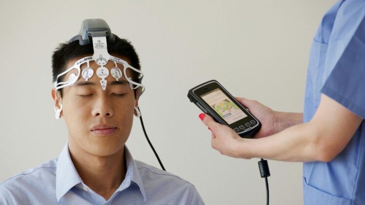 Man wearing a brain scanning device .