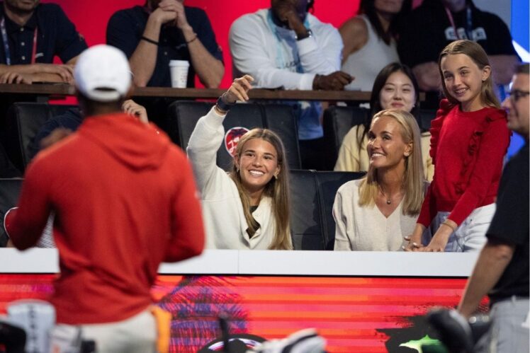 Kai Trump and her mother Vanessa Trump laugh with Tiger Woods