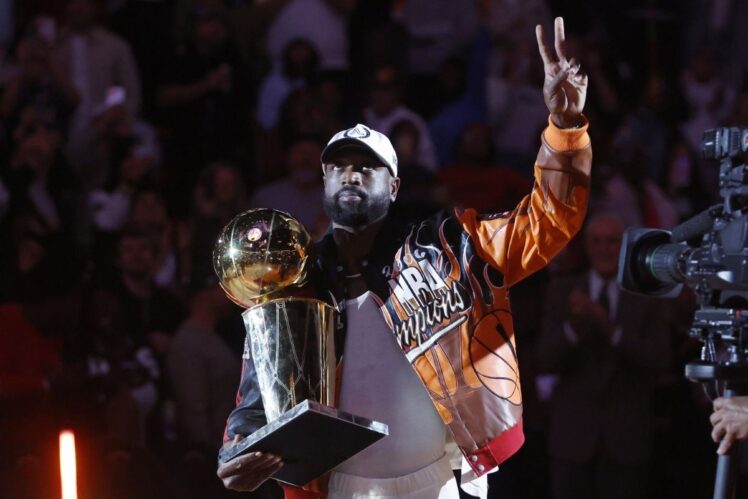 Dwayne Wade holds the Larry O' Brien trophy