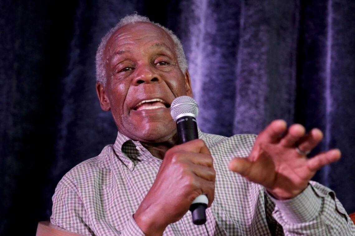 Actor Danny Glover speaking into a microphone.
